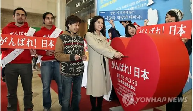 ソウル市内のロッテ百貨店で韓国外国語大学の学生らが東日本大震災を支援するため募金活動を行っている＝20日、ソウル（聯合ニュース）