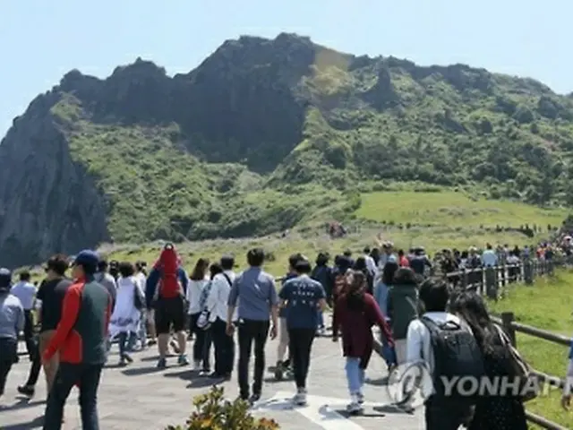 観光客でにぎわう済州島の巨大岩山「城山日出峰」＝（聯合ニュース）