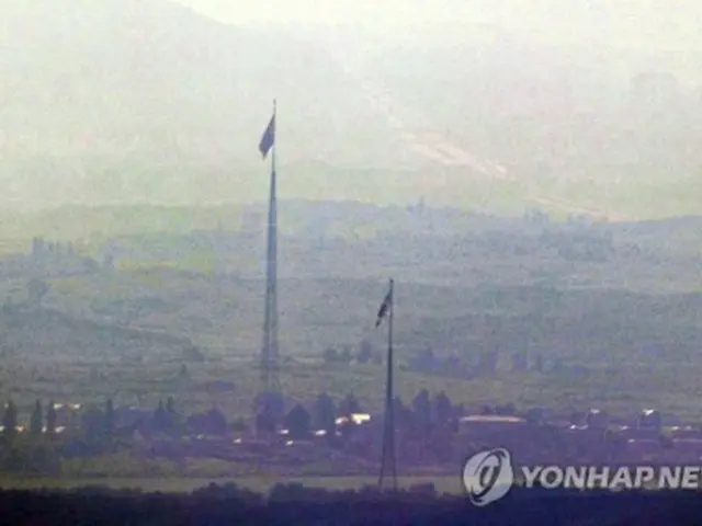 韓国の京畿道・坡州の南北軍事境界線近くから眺めた非武装地帯（ＤＭＺ）の様子。韓国と北朝鮮の国旗が掲げられている＝２７日、坡州（聯合ニュース）