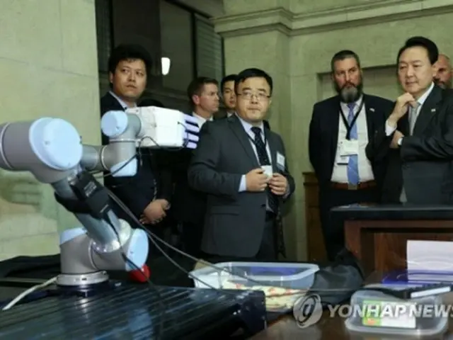 トロント大で研究中のロボットの実演を見る尹大統領（右端）＝２２日、トロント（聯合ニュース）