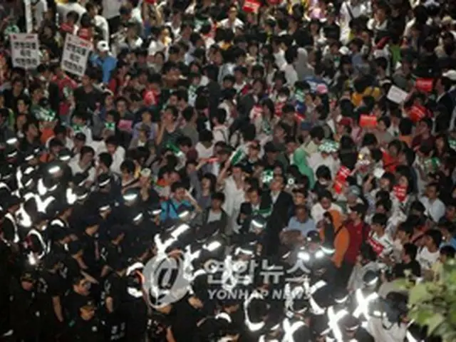 26日夜、街頭デモを始めようとする集会参加者と、妨げる警察＝（聯合）