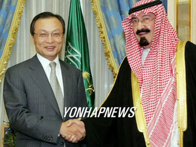 握手する李首相とアブドラ国王＝２８日、リヤド（聯合）