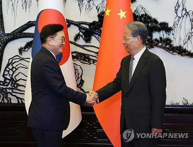 握手を交わす韓国の禹元植・国会議長（左）と中国の趙楽際・全国人民代表大会常務委員長（国会議長室提供）＝（聯合ニュース）≪転載・転用禁止≫