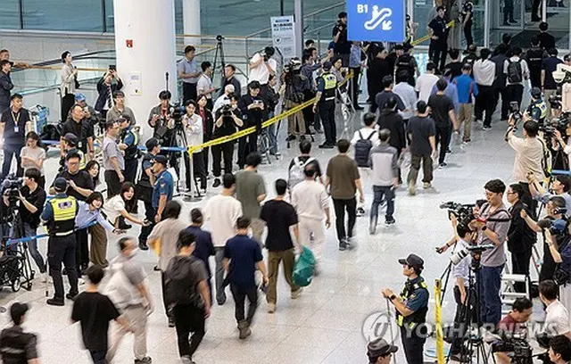 釈放されて仁川国際空港に到着した韓国人労働者たち＝１２日、仁川（聯合ニュース）