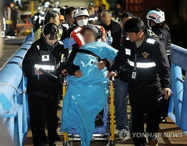 救助される乗客ら＝１９日、木浦（聯合ニュース）