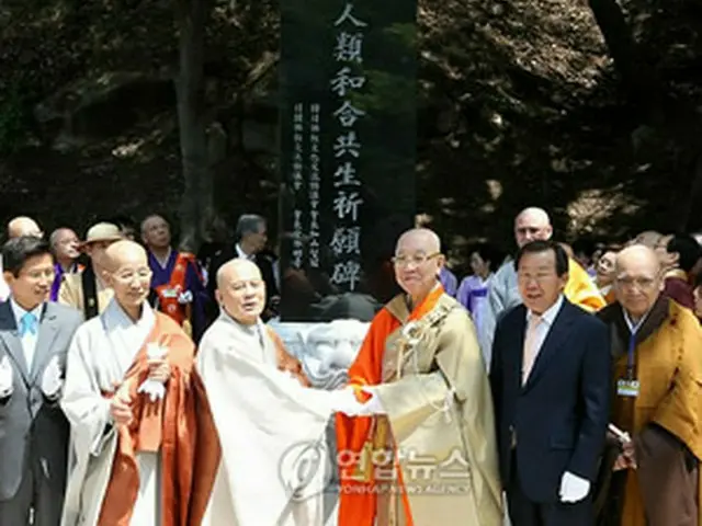 「人類和合共生祈願碑」除幕式で握手を交わす韓国・曹渓宗総務院長の智冠法師（左から3人目）と宮林会長（右から3人目）＝13日、驪州（聯合ニュース）