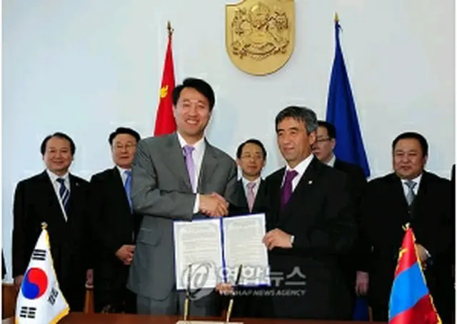 ＭＯＵ締結後、握手する呉市長とムンフバヤル市長＝２６日、ウランバートル（聯合ニュース）