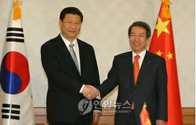 握手を交わす鄭首相（右）と習近平副主席＝17日、ソウル（聯合ニュース）