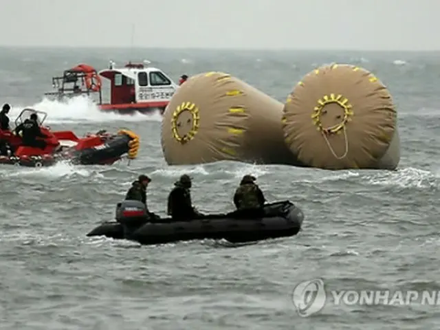 捜索活動を行う救助チーム＝（聯合ニュース）