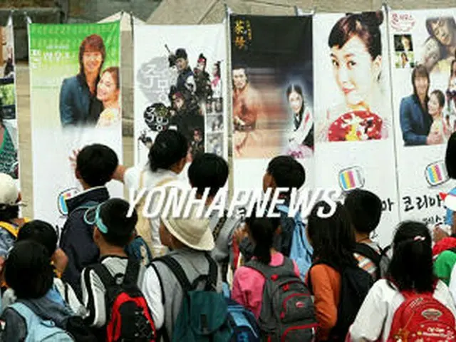 ドラマフェスティバルに訪れた人たちがさまざまなドラマのポスターを眺めている＝26日、晋州（聯合）