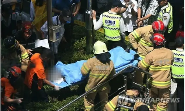 やけどを負い病院に搬送される男性＝１２日、ソウル（聯合ニュース）