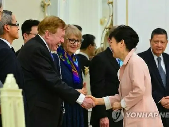 賢人グループのメンバー、キング氏（左）と握手を交わす朴大統領＝２８日、ソウル（聯合ニュース）
