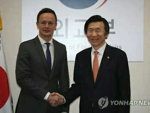 握手を交わす尹長官（右）とシーヤールトー外務貿易相＝１６日、ソウル（聯合ニュース）
