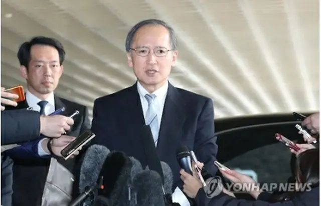 金浦空港で記者に囲まれる長嶺氏＝９日、ソウル（聯合ニュース）