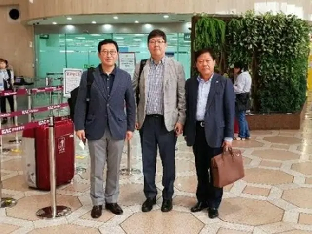 金浦空港を出発する金弘傑氏（中央、民和協提供）＝１４日、ソウル（聯合ニュース）