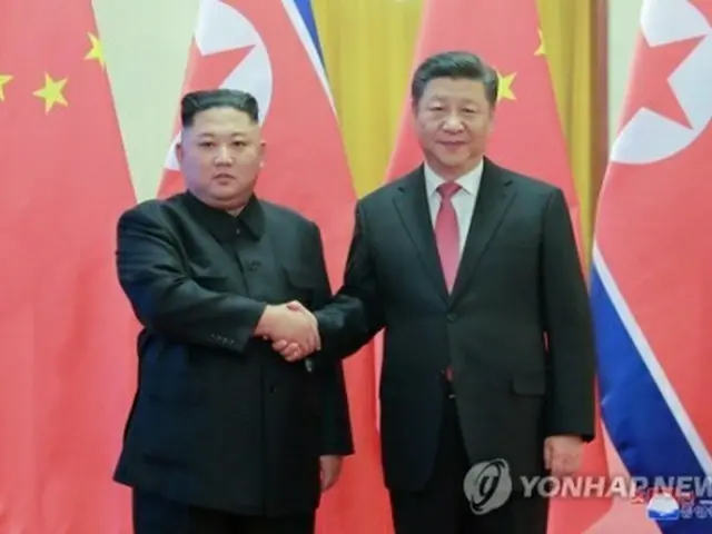 ８日の首脳会談で握手を交わす金委員長（左）と習主席＝（朝鮮中央通信＝聯合ニュース）