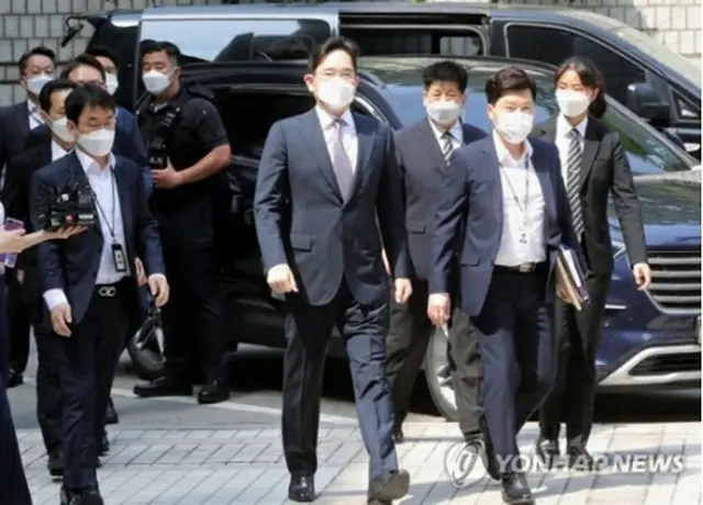 ソウル中央地裁に到着した李氏（中央）＝8日、ソウル（聯合ニュース）