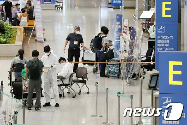 韓国 仁川空港で海外入国者が医療陣から質問を受けている（提供:news1）