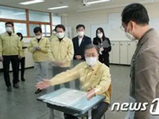 修能試験受験生の机に座る文大統領「最後まで緊張を」＝韓国