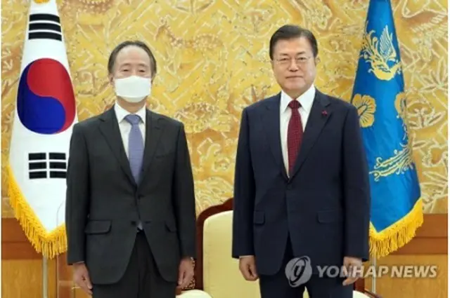 文大統領（右）と冨田氏（青瓦台提供）＝１４日、ソウル（聯合ニュース）≪転載・転用禁止≫