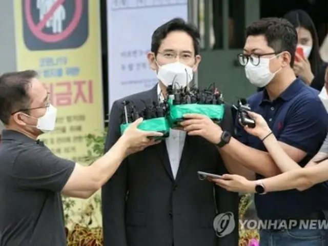 ソウル拘置所前で報道陣に囲まれる李氏＝１３日、義王（聯合ニュース）