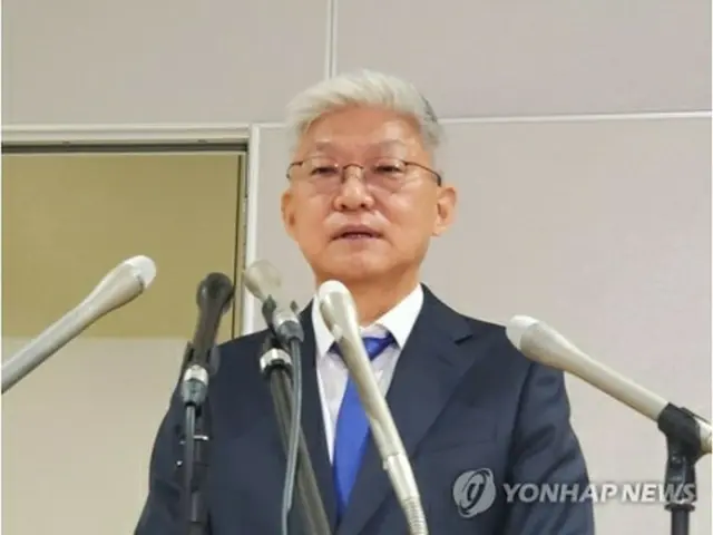 先月16日、羽田空港に到着し記者の質問に答える尹徳敏氏＝（聯合ニュース）