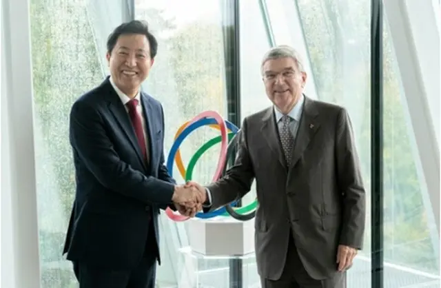 IOC本部で握手を交わす呉氏（左）とバッハ会長（ソウル市提供）＝（聯合ニュース）≪転載・転用禁止≫
