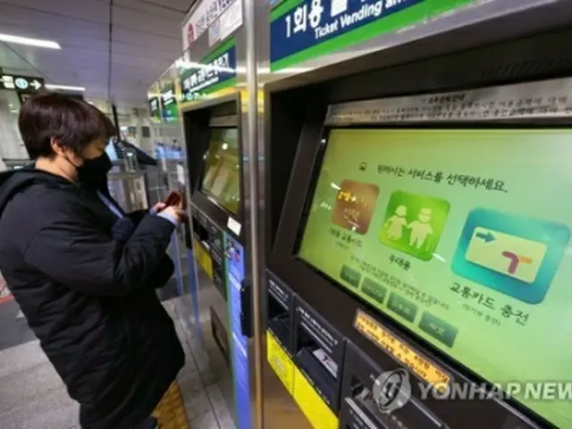 ソウル地下鉄1号線の市庁駅で地下鉄の切符を買う外国人観光客＝26日、ソウル（聯合ニュース）