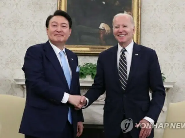 会談で握手を交わす尹大統領（左）とバイデン大統領＝２６日、ワシントン（聯合ニュース）