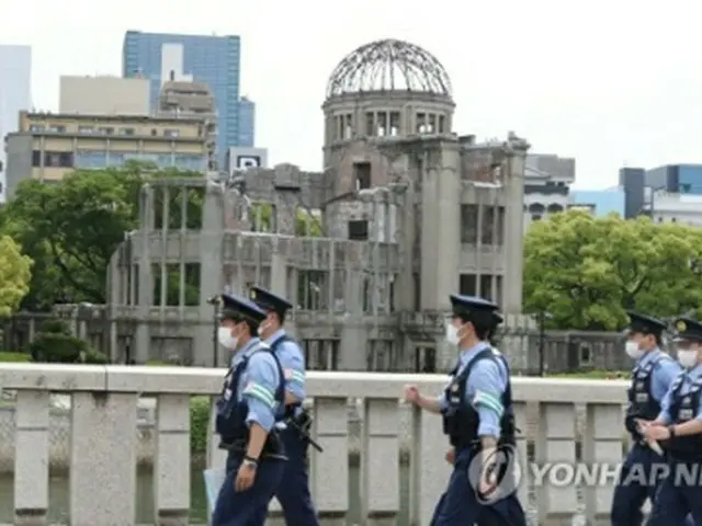 G7サミットの開幕を翌日に控えた広島市内は警戒態勢が敷かれている。原爆ドームの近くで警戒に当たる警察＝18日、広島（聯合ニュース）