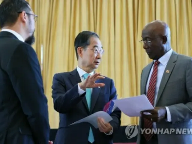 トリニダード・トバゴを訪れている韓首相（中央）。同国のローリー首相（右）と話を交わしている（国務総理室提供）＝（聯合ニュース）≪転載・転用禁止≫