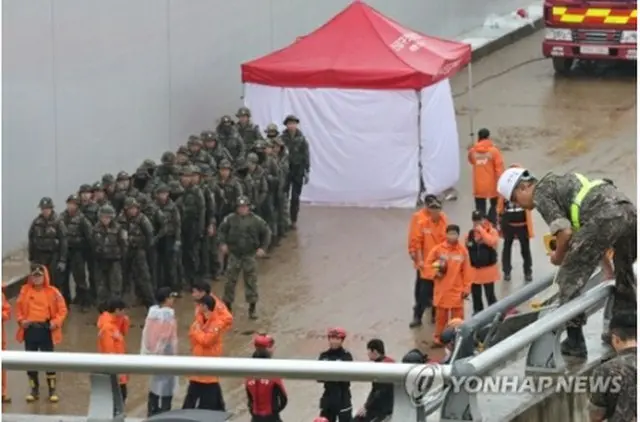 浸水事故の現場で行方不明者の捜索を行う将兵と消防隊員＝１７日、清州（聯合ニュース）