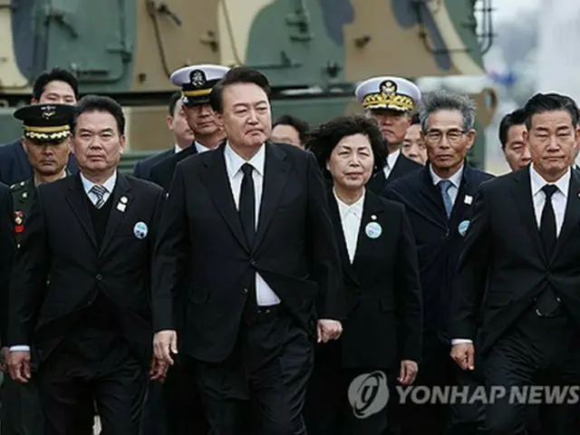 「西海守護の日」記念式典の会場に入る尹大統領（中央）と、遺族や将兵の代表＝２２日、平沢（聯合ニュース）