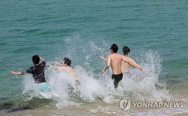 韓国の各地で真夏日となった２０日、江原道江陵市の海に飛び込む観光客ら＝２０日、江陵（聯合ニュース）