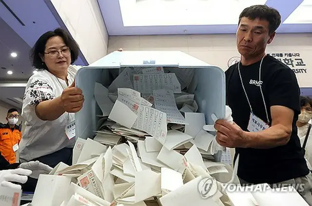 ソウル市内の開票所で開けられる投票箱＝３日、ソウル（聯合ニュース）