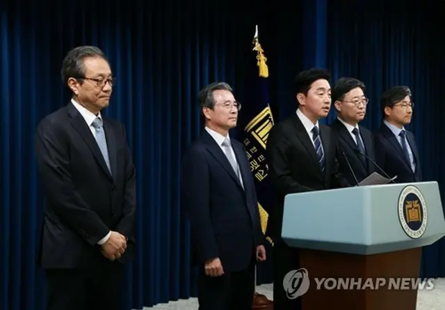 大統領室首席秘書官の人選を発表する姜勳植・大統領秘書室長（中央）。左から２人目が金容範氏＝６日、ソウル（聯合ニュース）