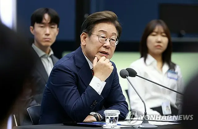 懇談会で出席者の質問に答える李大統領（大統領室通信写真記者団）＝１１日、ソウル（聯合ニュース）