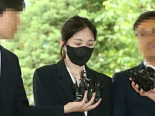 頭を下げながら護送されるソ・ミンジェ